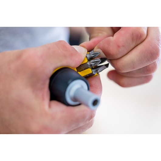 STANLEY 0-66-358 multi-bit screwdriver close-up, showing interchangeable bits in yellow holder.