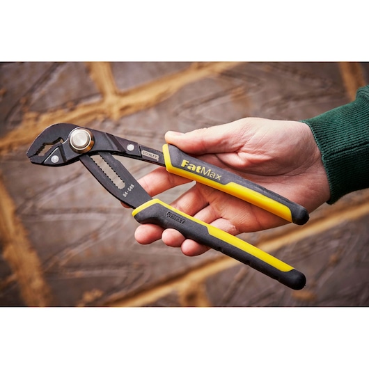 STANLEY 0-84-648 water pump pliers, FatMax, black and yellow handles, held in hand.