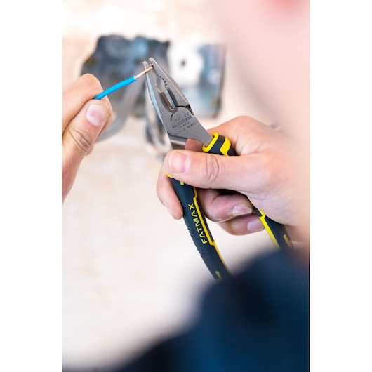 Photo of STANLEY 0-89-866 FATMAX pliers gripping a copper wire with blue insulation during electrical work.