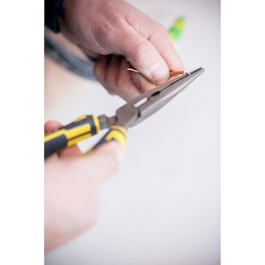 Photo of STANLEY 0-89-870 long nose pliers with yellow and black handle gripping wire, close-up.