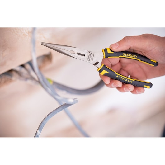 Stanley 0-89-870 FATMAX long nose pliers with black and yellow handles held, gripping electrical wire.