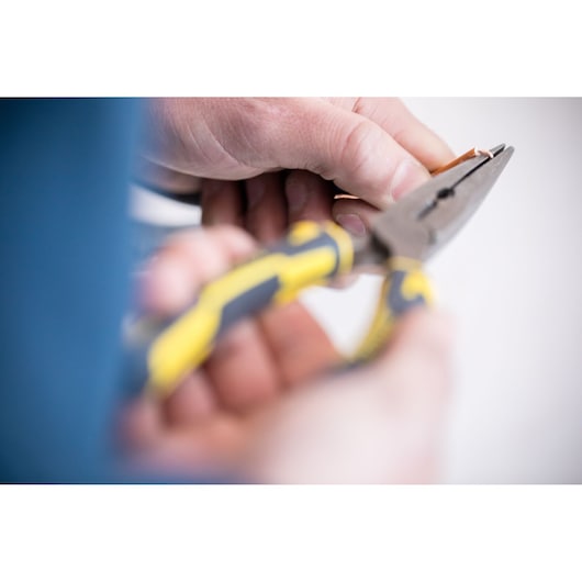 STANLEY 0-89-870 pliers with yellow and black handles in use, close-up photography.