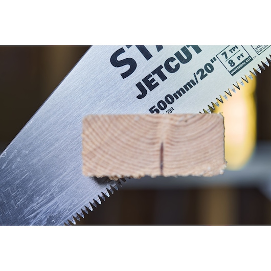 STANLEY 2-15-288 hand saw blade with wood piece, close-up side view showing teeth and markings.