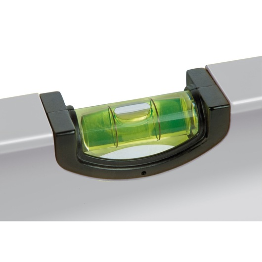 Close-up of a Stanley spirit level showing the green bubble vial for precise leveling.